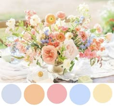 a vase filled with flowers sitting on top of a table next to plates and utensils