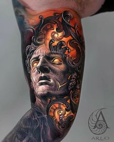 a man's leg with tattoos on it and an image of a face in the middle