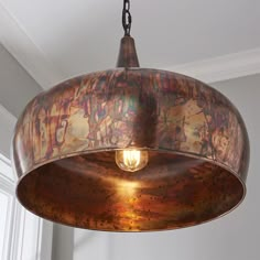 a light hanging from a ceiling in a room