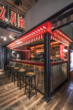 a bar with stools and neon lights