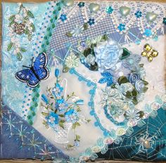 a close up of a piece of cloth with flowers and butterflies on it in blue