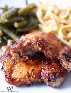 two pieces of chicken, green beans and pasta on a plate