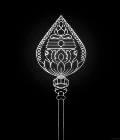 a black and white photo of a lamp in the dark with an intricate design on it