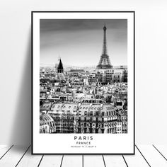 a black and white photo of the eiffel tower in paris, france on a wooden floor