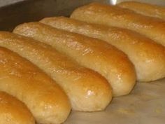 bread rolls lined up on a baking sheet