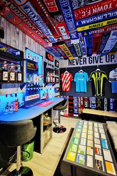 the inside of a sports shop with many items on display and signs hanging from the ceiling