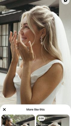 a woman in a white wedding dress is smiling and clapping her hands to the side