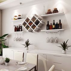 there are many bottles and glasses on the shelves above the table in this dining room