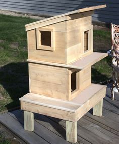 a bird house sitting on top of a wooden platform