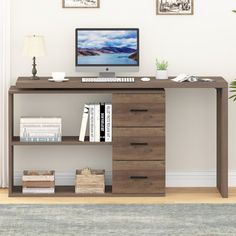 a desk with a computer on top of it and some books in front of it