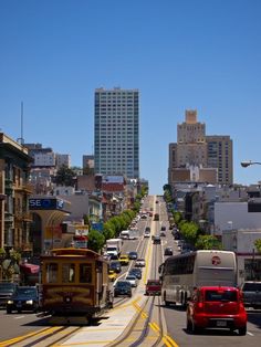 a street filled with lots of traffic next to tall buildings on the side of it