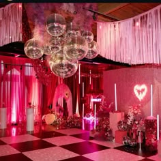 a room filled with lots of pink and white decorations on top of a checkered floor