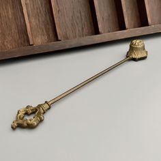 an antique brass door handle on a white surface