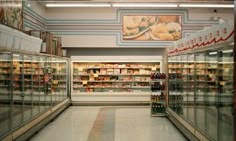 an empty grocery store aisle with lots of food in the aisles and on display shelves