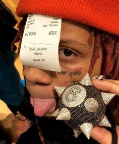 a woman sticking her tongue out with a fake star on top of her nose and the receipt taped to her face