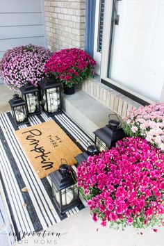 front porch decorated with flowers and lanterns for the welcome sign to someone's home