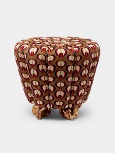 an intricately designed stool made out of wood and fabric, with two legs on each side