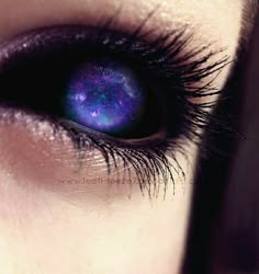 a woman's blue eye with stars in the iris