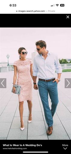 a man and woman walking down a sidewalk