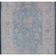 an antique rug with blue and pink colors