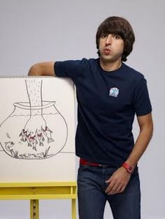 a man standing next to a drawing on a easel