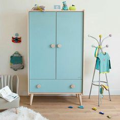 a baby's room with a blue cabinet and toys