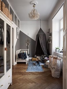 a bedroom with a bed, closet and chandelier hanging from it's ceiling