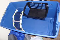 a blue plastic container with a laptop in it