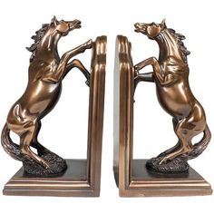 a pair of bronze bookends with horses on the front and back ends,