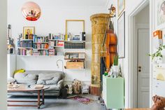 a living room filled with furniture and lots of books