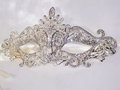 Beautiful silver rhinestone and pearl bridal, masquerade, Halloween, new years, etc.. mask. A very elegant holiday mask. Returns & exchanges I ship five days a week, Monday through Friday, via USPS First Class Mail. You'll find the cost of domestic US shipping with each item's listing. Expedited Shipping If you need your item quickly, you can choose USPS Priority shipping or Express shipping at check out. I gladly accept cancellations Request a cancellation within: 1 hours of purchase I don' White Masquerade Mask, Silver Masquerade Mask, Rhinestone Mask, Crystal Mask, Masquerade Outfit, Silver Mask, Bridal Mask, Bridal Business, Party Mask