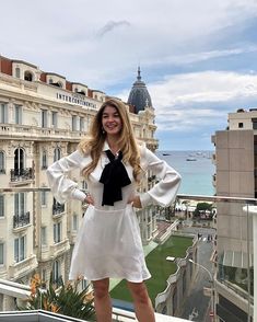 a woman standing on top of a building