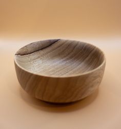 a wooden bowl sitting on top of a table