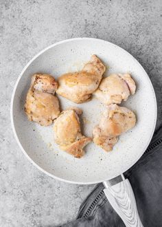 a white plate topped with chicken wings on top of a table