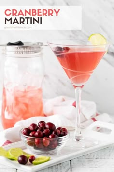 the cranberry martini is garnished with lime