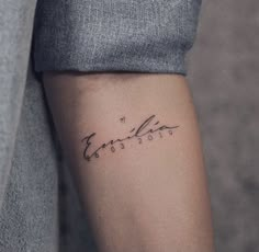 a person with a small tattoo on their arm that says,'love is in the air