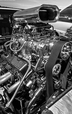 an engine is shown in this black and white photo with the hood up to show it's workings