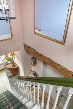 an overhead view of a staircase with pictures on the wall