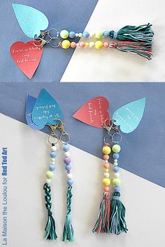 two pictures of the same keychain with hearts and tassels on them