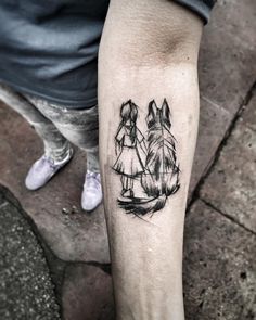 a person with a tattoo on their arm that has a drawing of two people holding hands