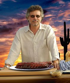 a man standing in front of a plate of food with a cactus in the background