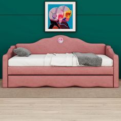 a pink daybed against a teal wall in a room with hardwood flooring