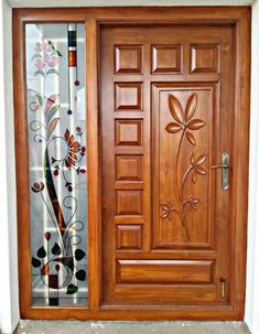 a wooden door with decorative glass on it