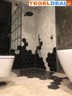 a bathroom with black and white tiles on the walls