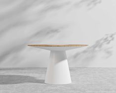 a white table sitting on top of a cement floor