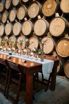 the table is set with candles and wine barrels