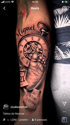 a man's arm with a clock and hand holding a key tattoo on it