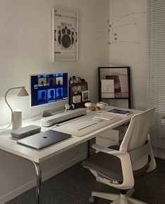 a white desk with a computer on top of it