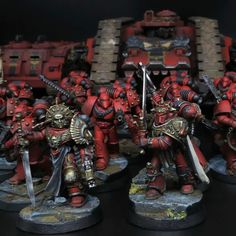 some red and black warhammers are standing next to each other