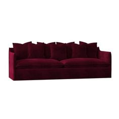 a red velvet couch with pillows on it's back and arms, in front of a white background